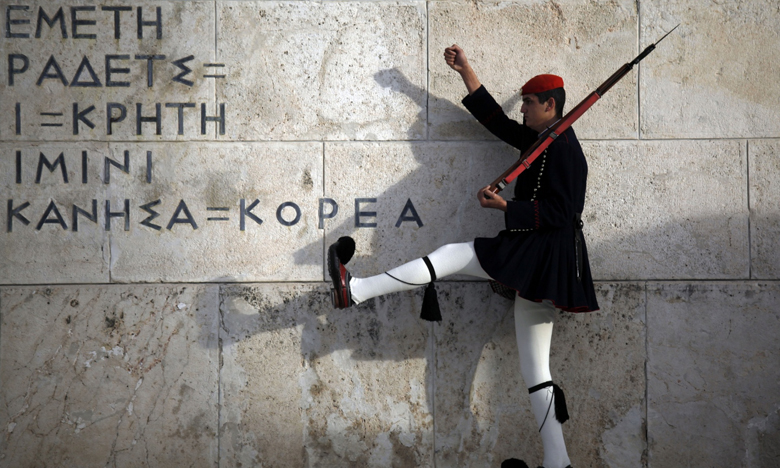 A Greek presidential guard performs a ceremonial march at the monument of the unknown soldier in front of the parliament building in Athens on Saturday. Photograph: Kostas Tsironis/AP