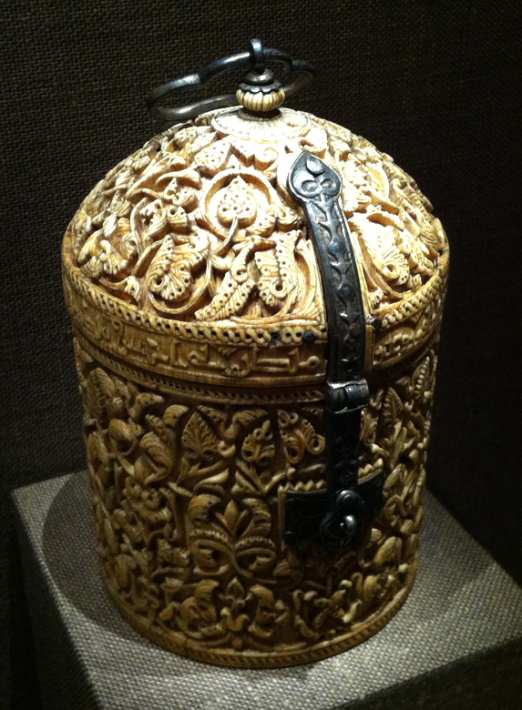 Cylindrical Box (Pyxis). Maker: Khalaf. Spain, Madinat al-Zahra. Spanish Umayyad period (756-1031), ca. A.H. 355/A.D. 966. Ivory; carved with gilded-silver mounts and niello inlay. Metropolitan Museum of Art, on loan from The Hispanic Society.